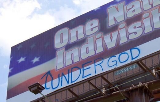 "One Nation Indivisible" spiller på amerikanernes Pledge of allegiance som opprinnelig ikke hadde ordene "under God" med. Dette kom inn på 50-tallet, og det er åpenbart mange som fortsatt vil ha de omstridte ordene der.